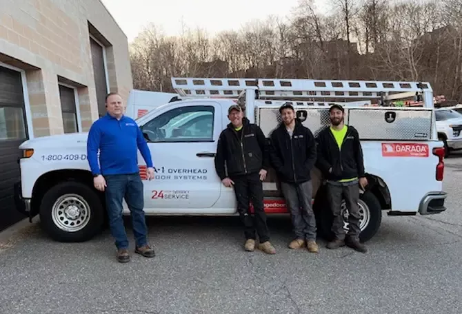 A-1 Overhead Door Systems technicians in front of a truck services